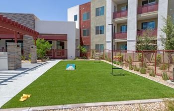 Outdoor courtyard with bocce ball and corn hole